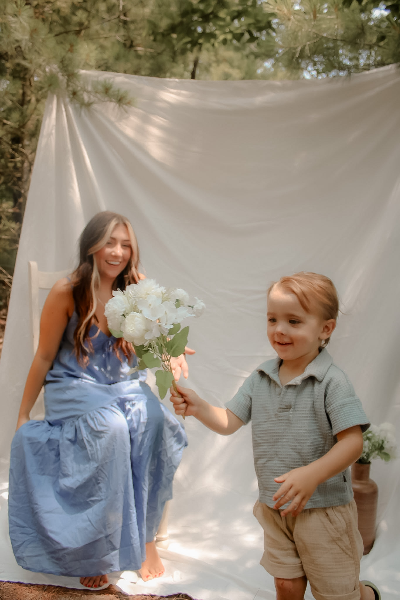 Smiling child carrying white flowers during an outdoor lifestyle session