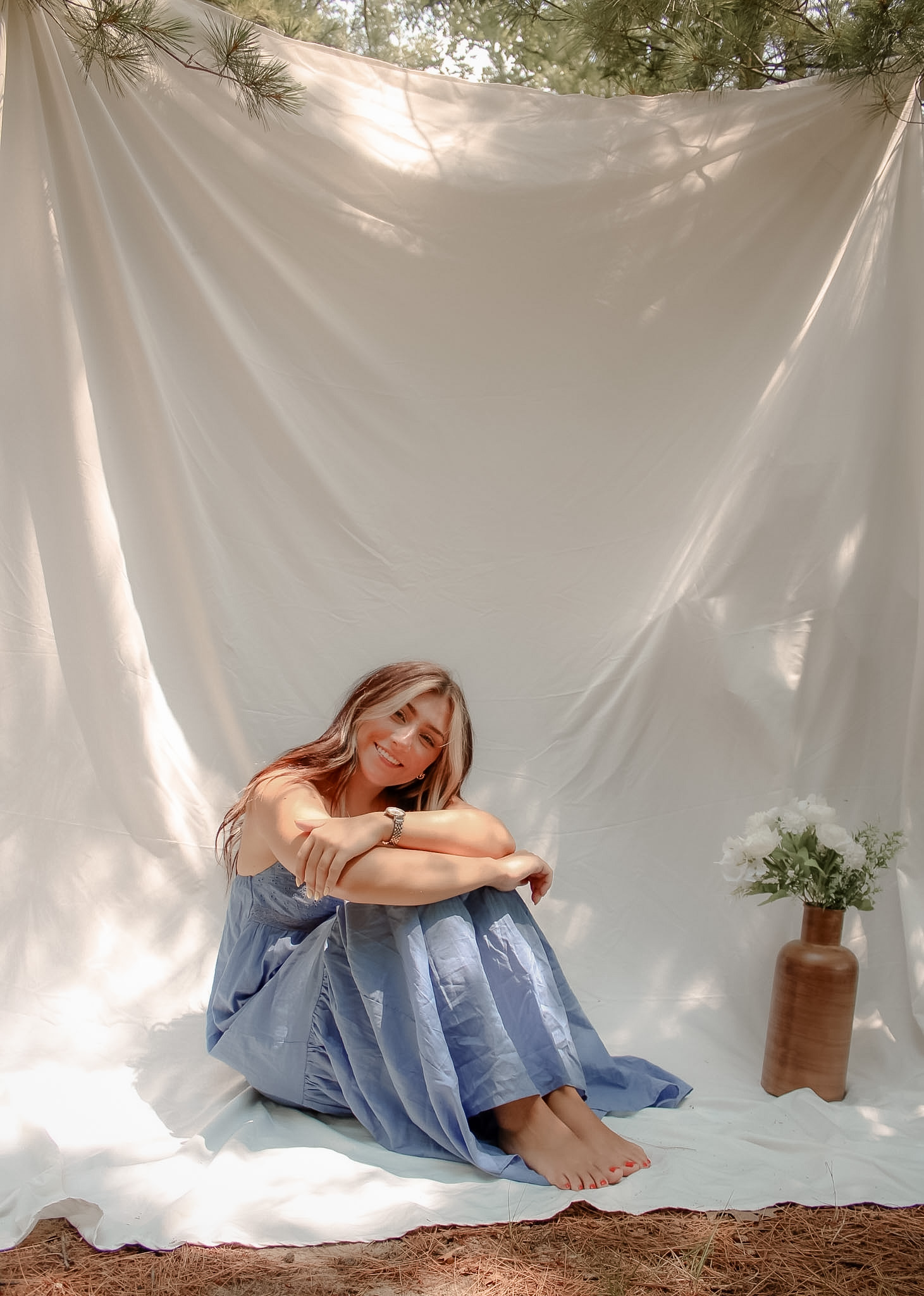 Seated outdoor portrait in a blue dress