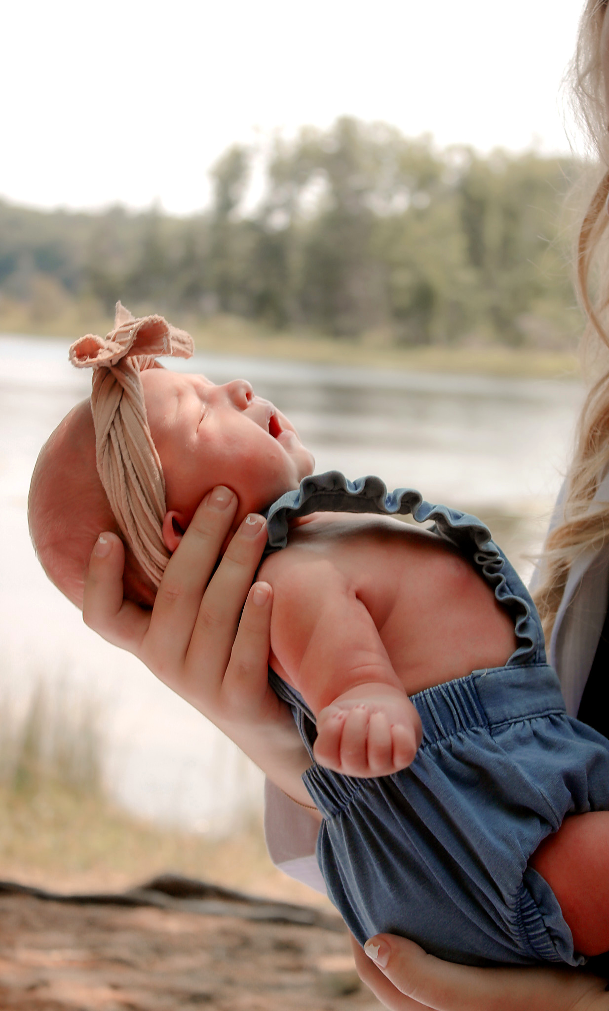 Newborn resting peacefully near the lakeshore