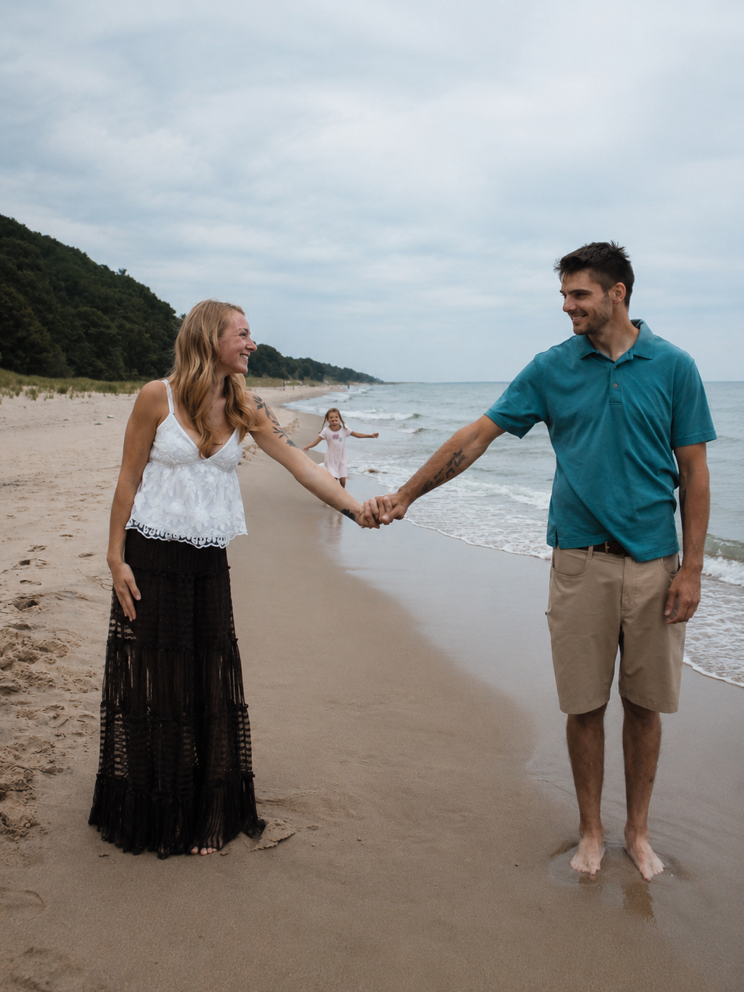 Family holding hands along the Lake Michigan shoreline