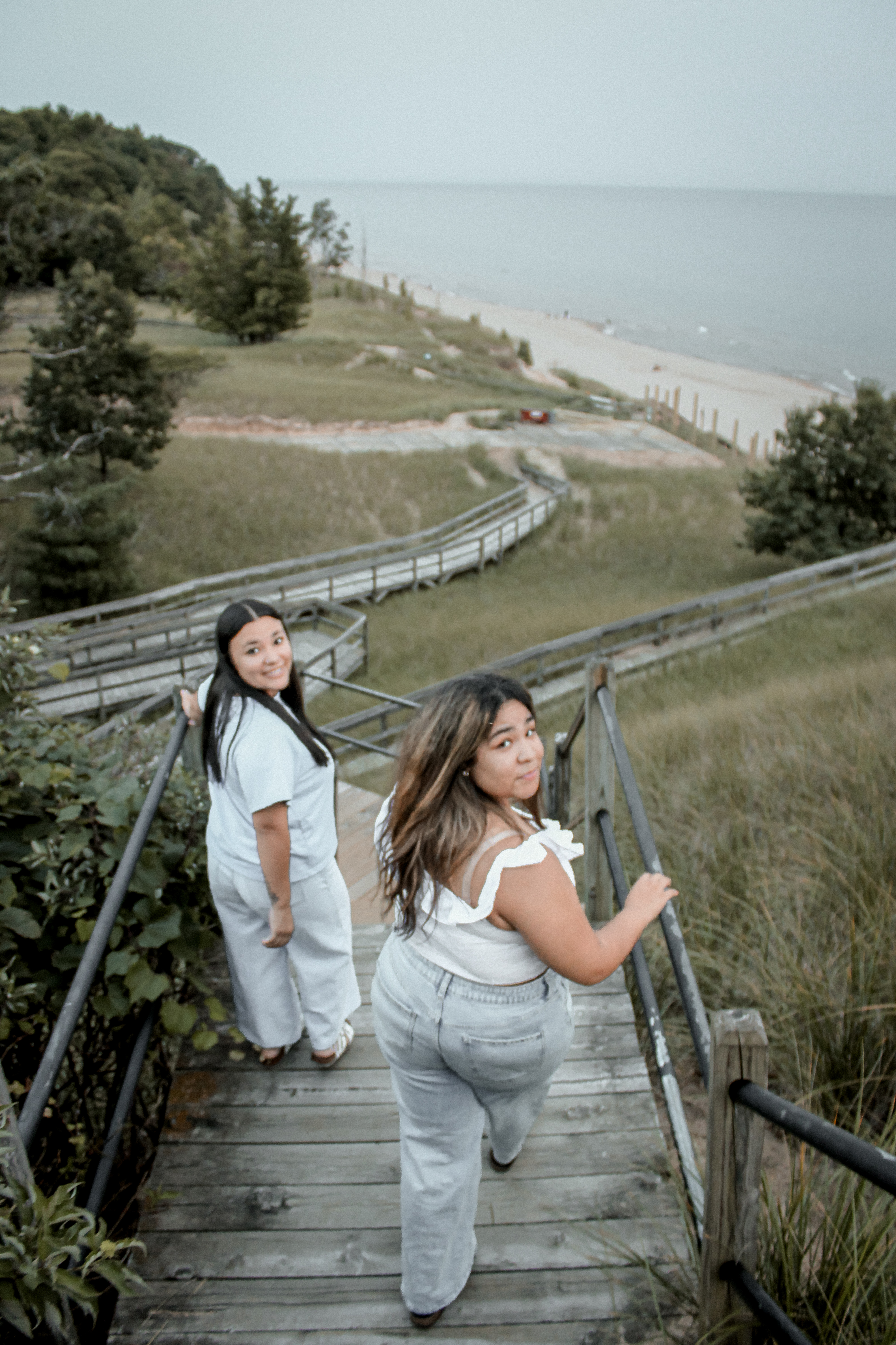 Two best friends walking together on a dune stairway