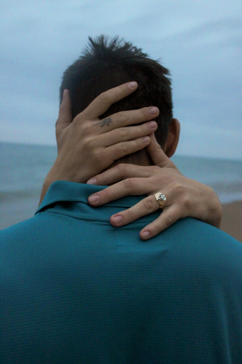 Detailed portrait of a couple embracing near the beach